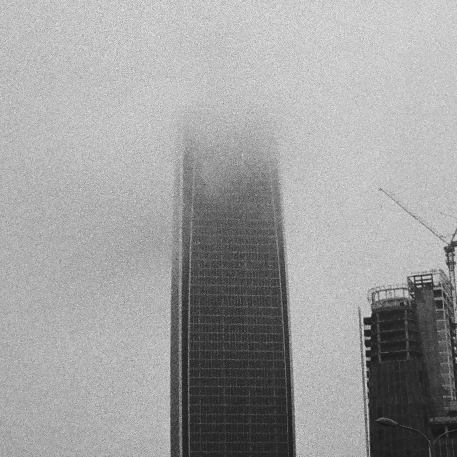 A skyscraper with its top hidden in the clouds