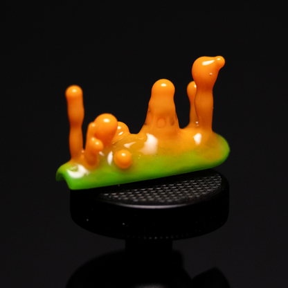 A handmade press-on nail design with an orange and green color scheme, with fuild and bubble-like shapes inspired by the shapes and colors of nudibranchs and lava lamps.