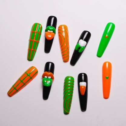 A set of Gothic-inspired press-on nails featuring bold green and orange designs, with striking 3D lips, teeth, and intricate patterns for an edgy, unique look.